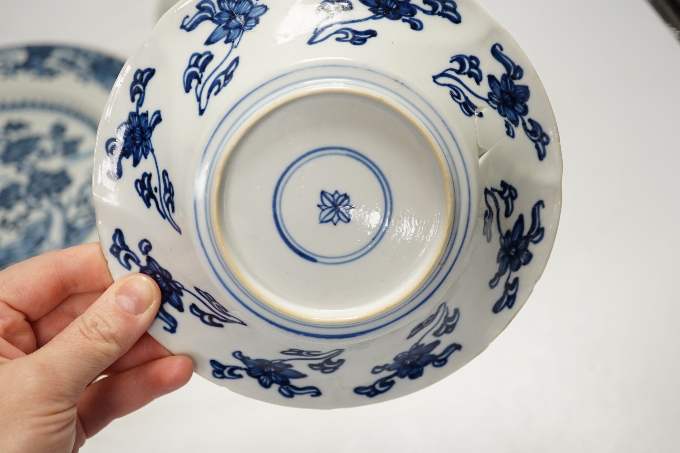 An 18th century Chinese export blue and white dish together with two others, largest 26cm